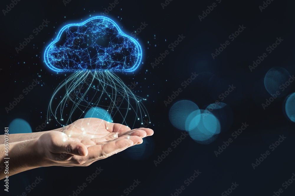 Close up of hand holding glowing blue digital cloud with binary code on dark blurry bokeh background