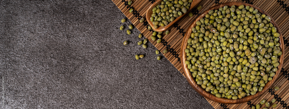 Raw mung bean on wooden table background.