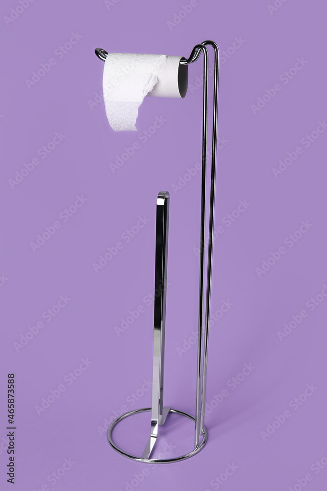 Holder with cardboard tube for toilet paper on purple background