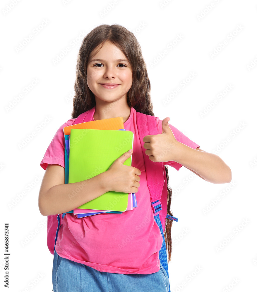 Little schoolgirl showing thumb-up, isolated on white