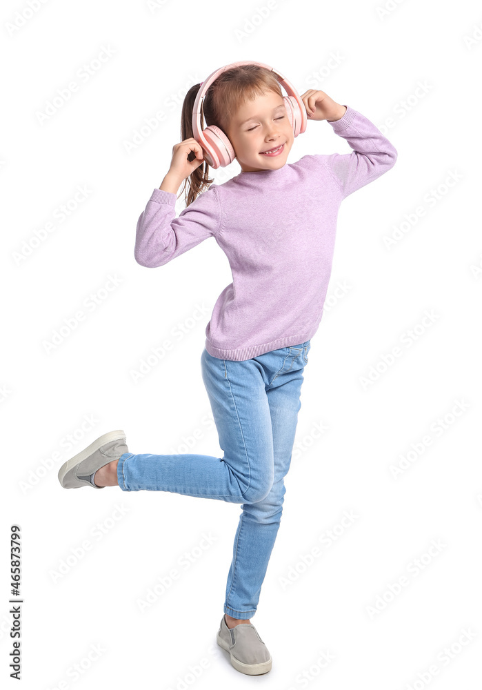 Funny little girl listening to music on white background