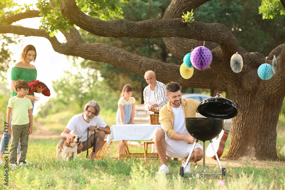 Happy family at barbecue party on summer day