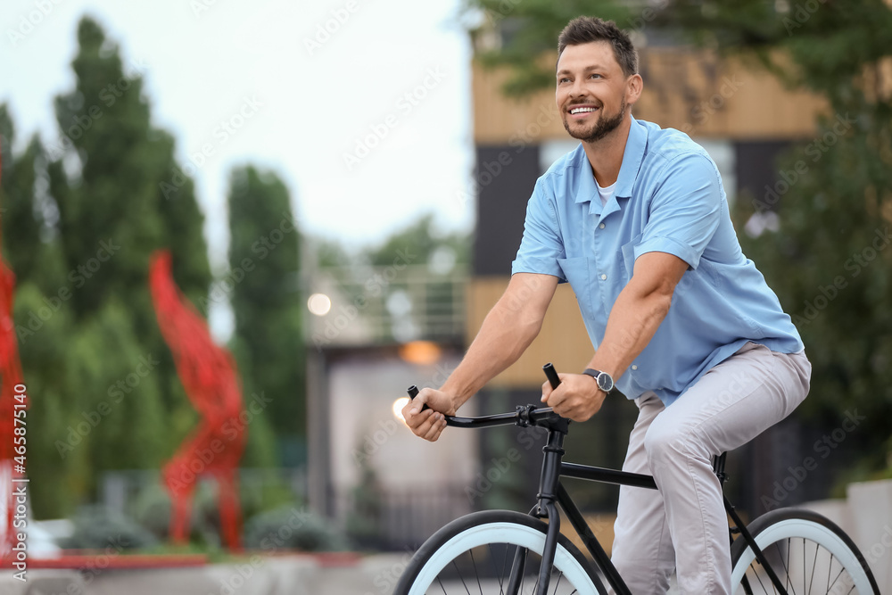 Man riding bicycle on city street