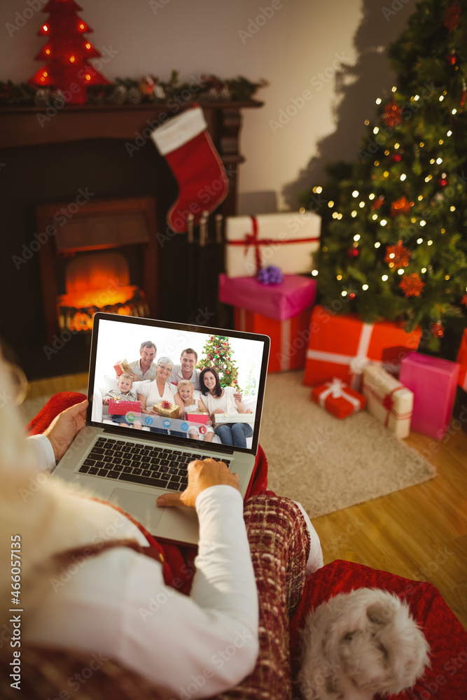 Santa claus making christmas laptop video call with happy caucasian multi generation family