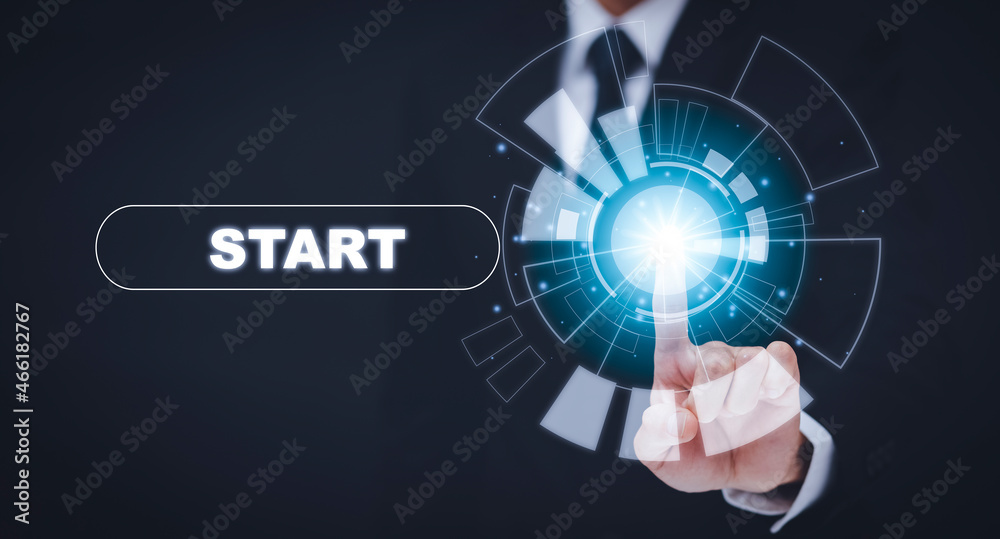 Businessman press start future button with virtual light, Start button with spot light on blue backg