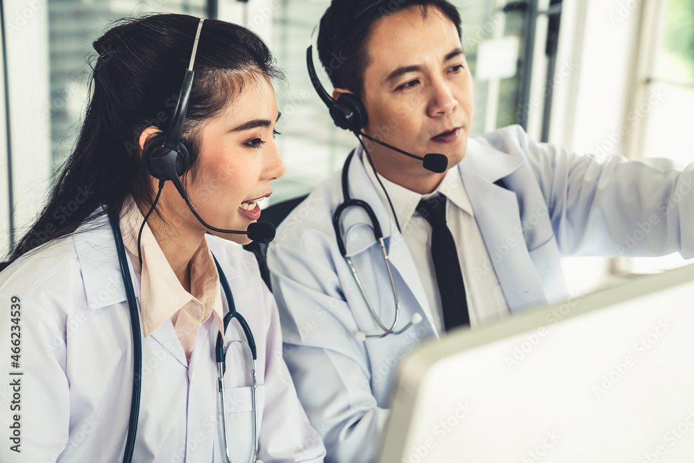 Doctor team wearing headset talking actively on video call in hospital clinic . Concept of telehealt