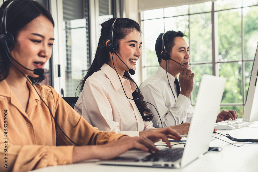 Business people wearing headset working actively in office . Call center, telemarketing, customer su