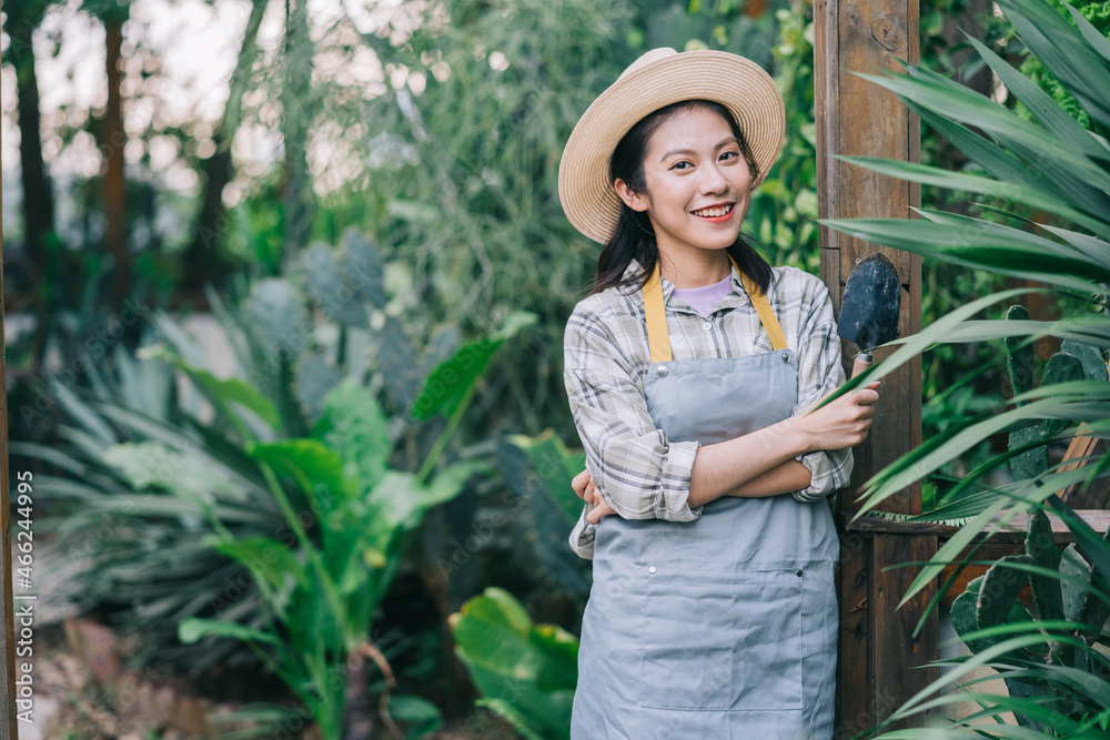 Young Asian woman takes care of the garden