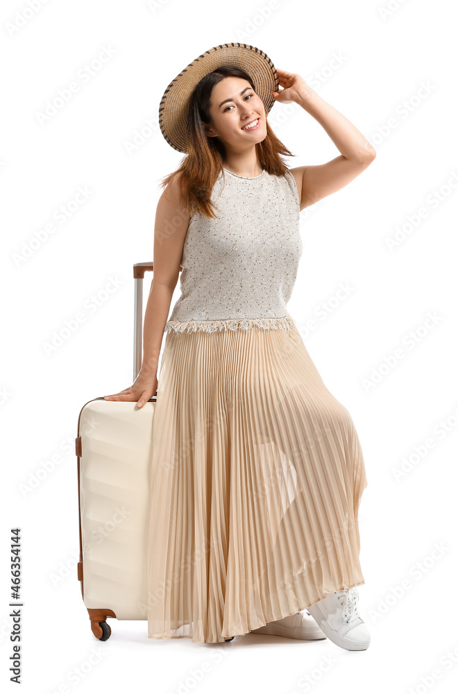 Young woman with suitcase on white background