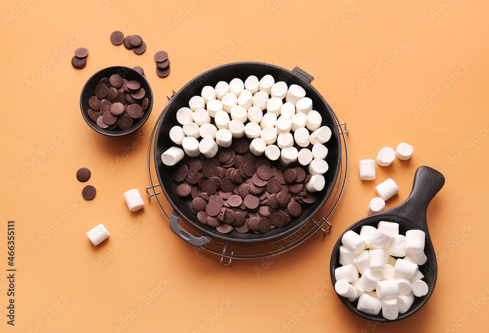 Frying pan with uncooked Smores dip on color background