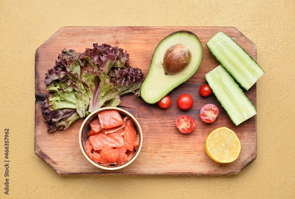 Board with ingredients for tasty salad on color background