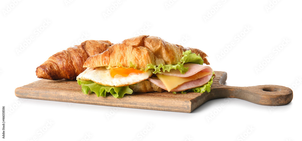 Wooden board with delicious croissant sandwiches on white background