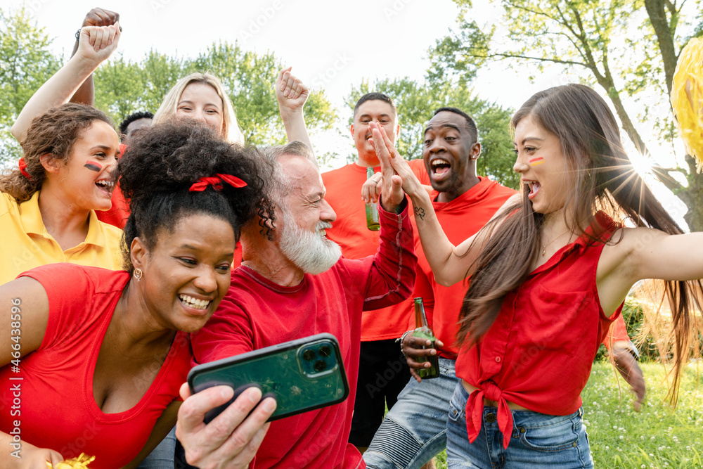 Supporters watching their team win the game on a mobile phone