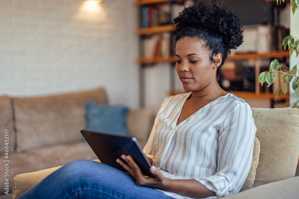 Serious african-american woman,watching the news