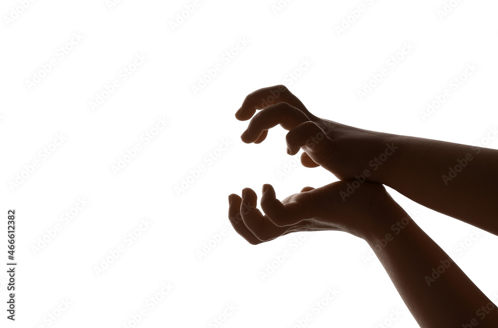 Child performing a shadow play on white background