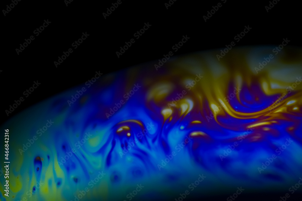 Abstract multicolor psychedelic planet in universe. Closeup soap bubble like an alien planet on dark