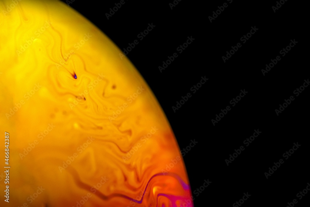 Abstract multicolor psychedelic planet in universe. Closeup soap bubble like an alien planet on dark