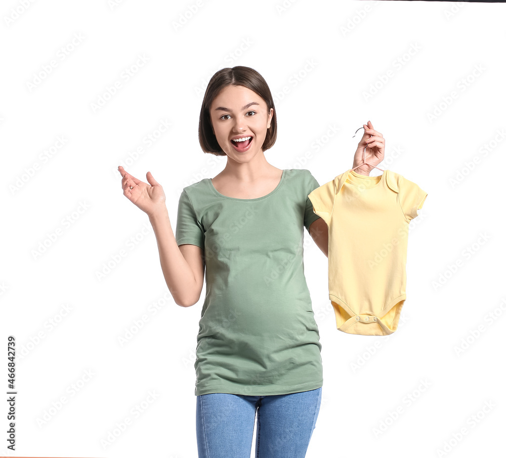 Surprised young pregnant woman with baby bodysuit on white background