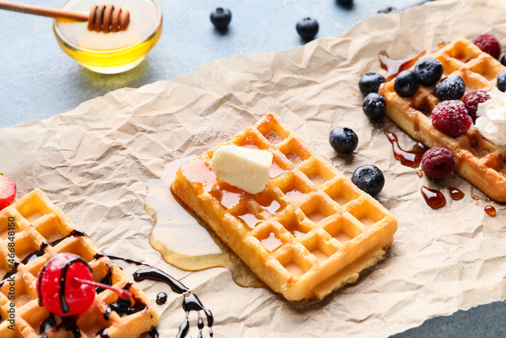 Tasty Belgian Waffles with berries on table