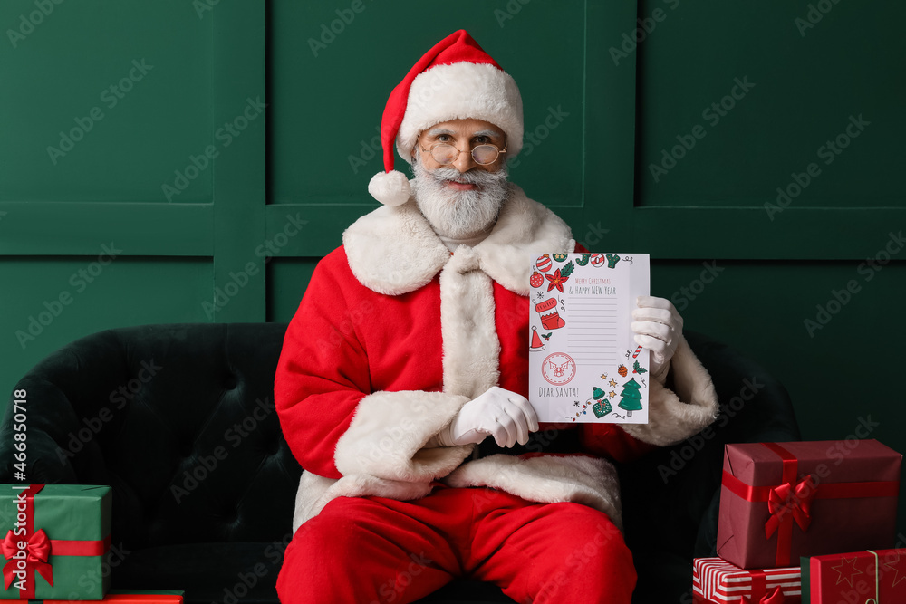 Santa Claus with empty letter at home on Christmas eve