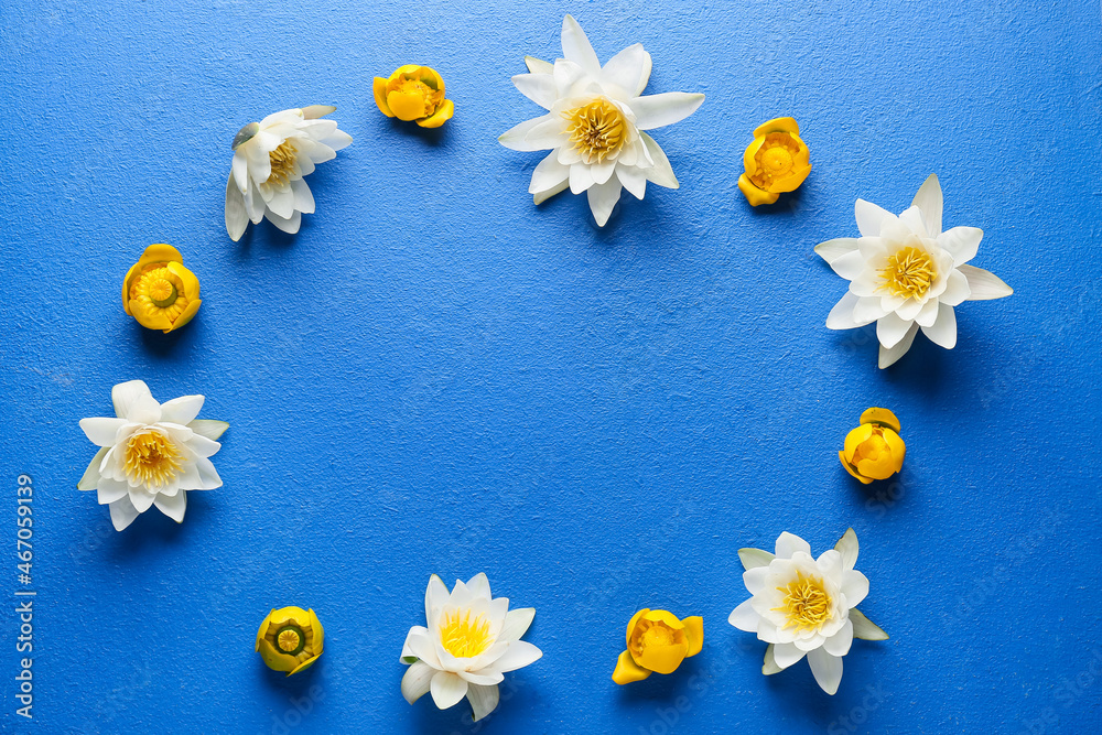 Frame made of white and yellow lotus flowers on blue background