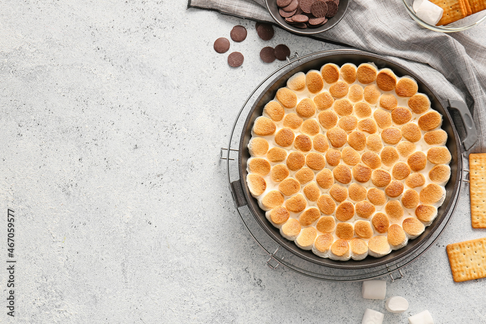 Frying pan with delicious Smores dip on light background