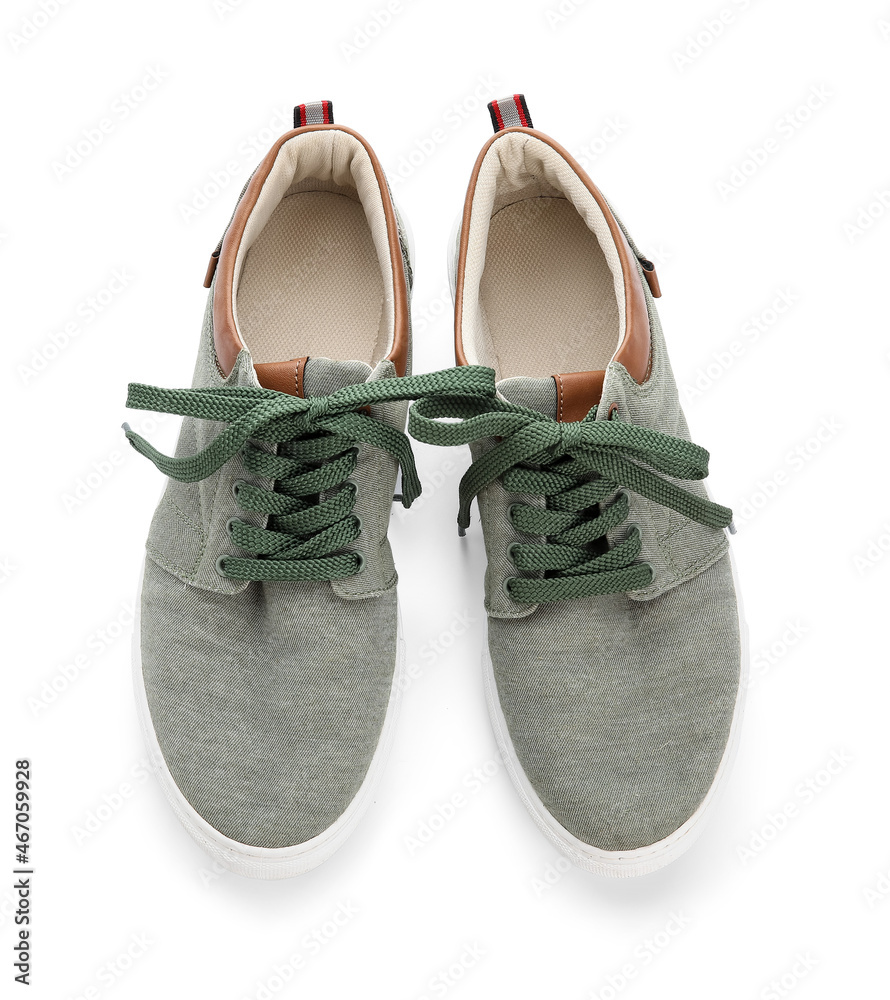 Pair of shoes with tied laces on white background