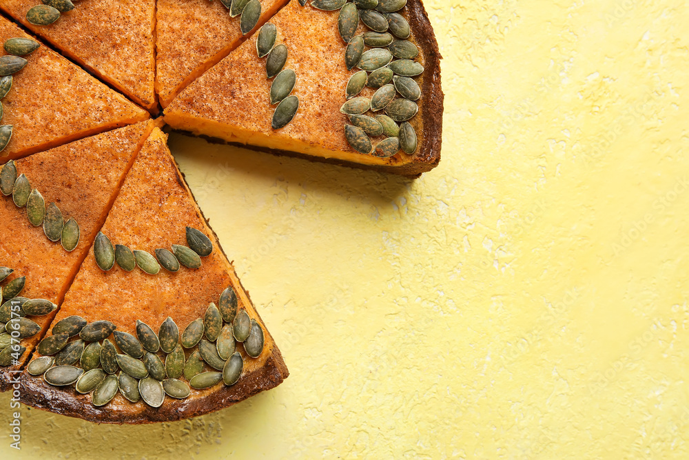 Cut pumpkin pie on yellow background, closeup