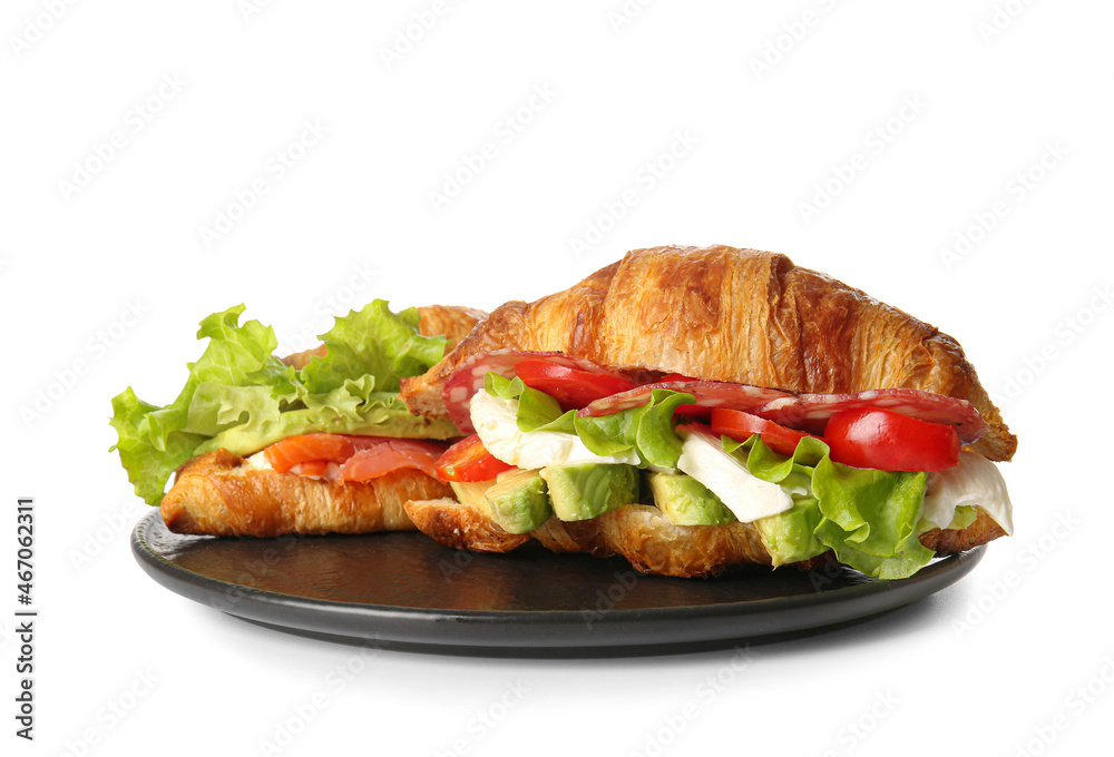 Plate with delicious croissant sandwiches on white background