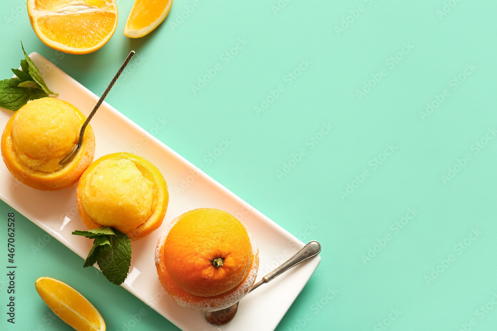 Plate with tasty ice creams in orange peels on color background