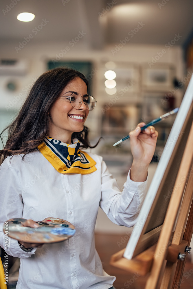 Adult woman, being careful with her new canvas