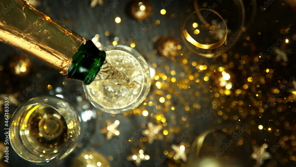 Top shot of pouring champagne wine into glass.