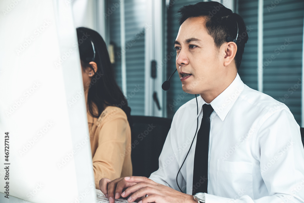 Business people wearing headset working actively in office . Call center, telemarketing, customer su