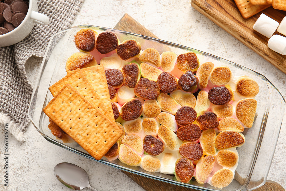 Baking dish with delicious Smores dip on light background