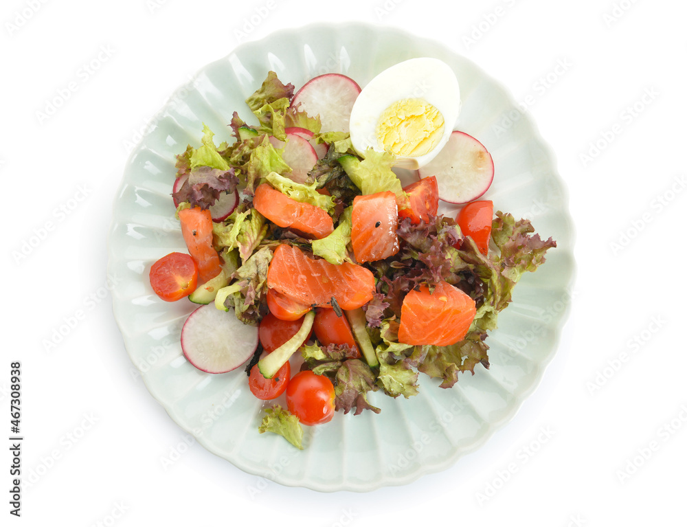 Tasty salad with salmon, egg and fresh vegetables in plate on white background