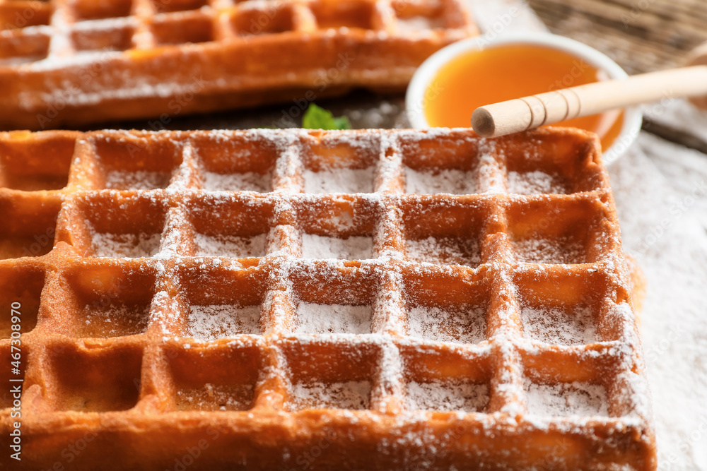 Delicious Belgian waffle on table, closeup