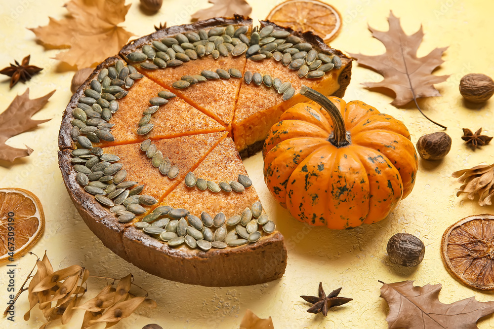 Composition with cut pumpkin pie on yellow background