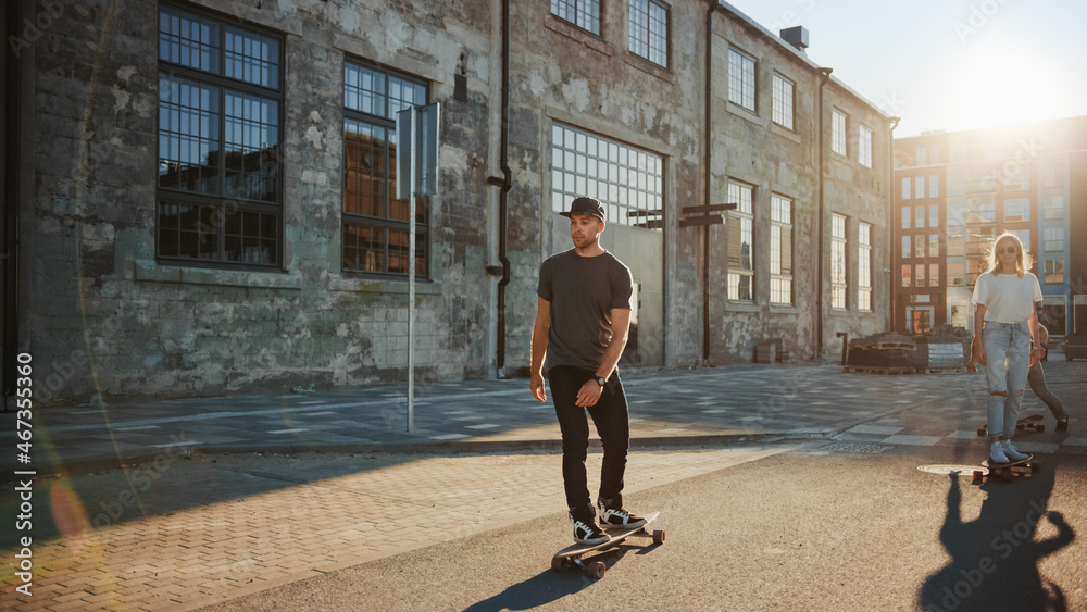 Group of Girls and Boys on Skateboards Through Fashionable Hipster District. Beautiful Young People 