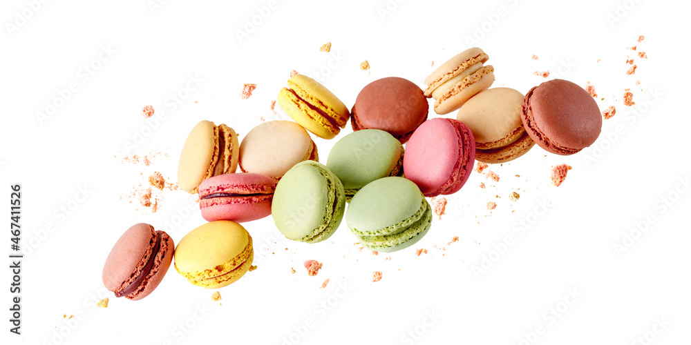 French  sweet colorful  mixed cookies macarons macaroons with crumbs flying isolated