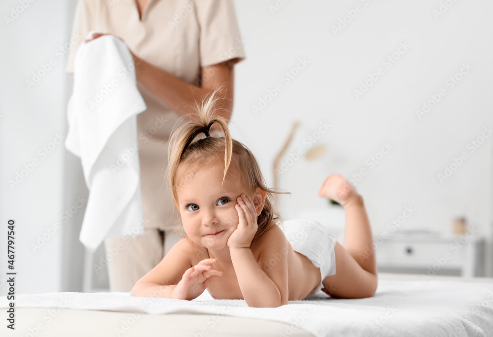 Massage therapist working with baby in medical center