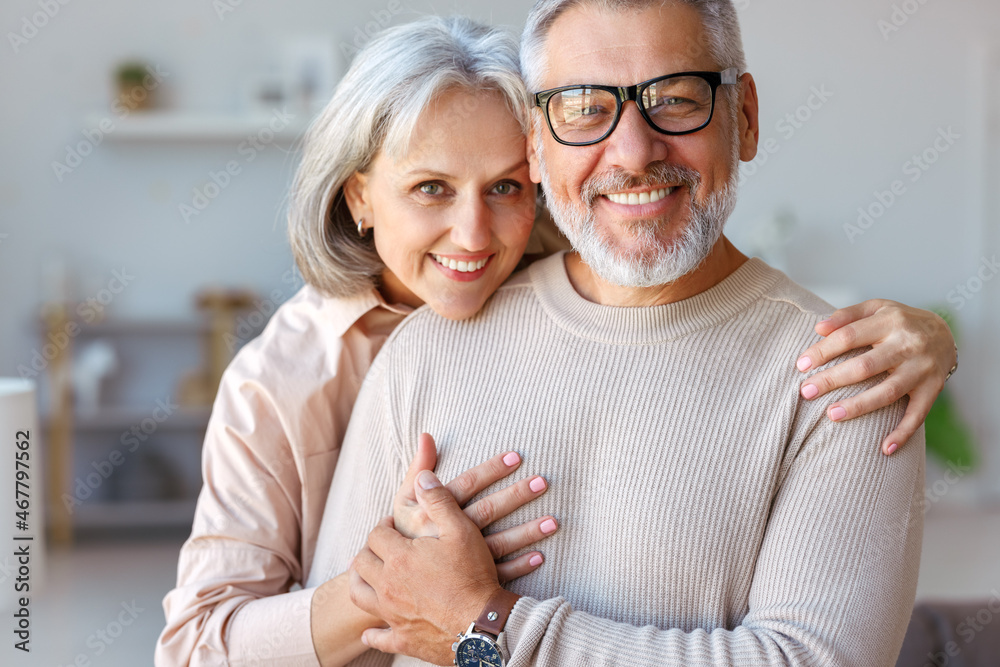 Beautiful smiling senior family couple husband and wife looking at camera with love