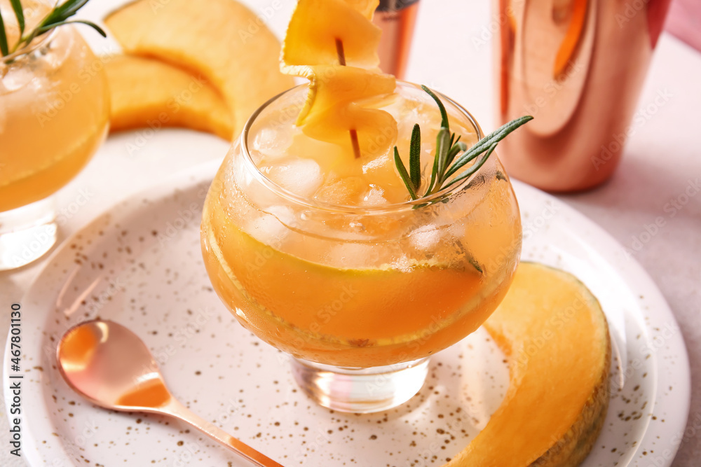 Glass with tasty melon cocktail on table, closeup