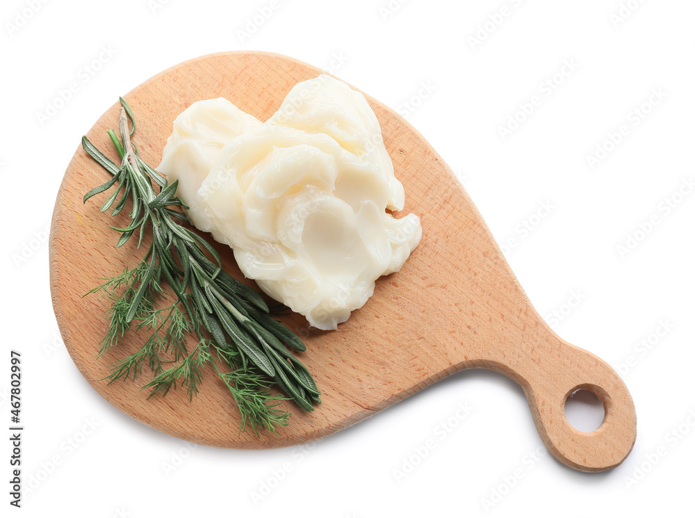 Board with lard and herbs on white background