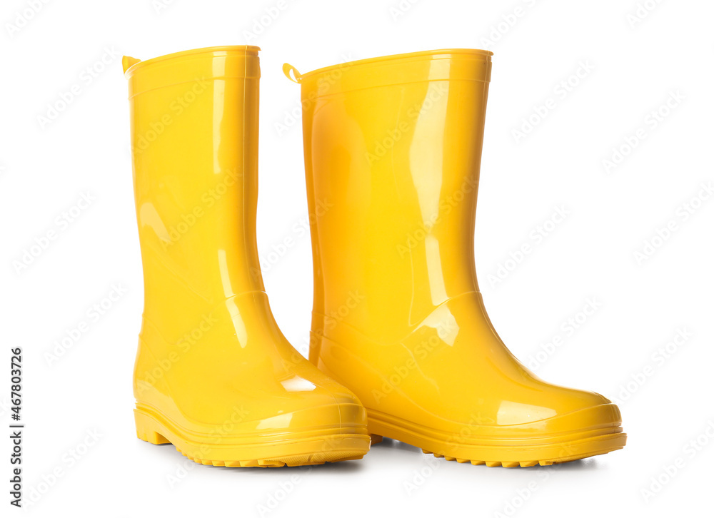 Pair of yellow rubber boots on white background