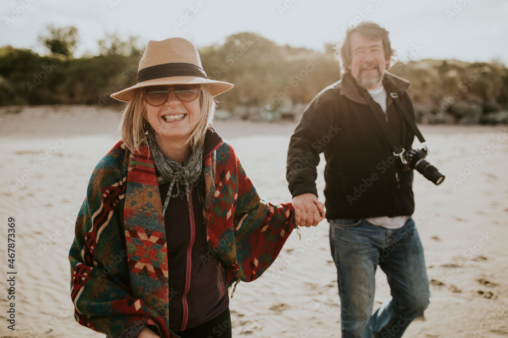 Retired senior couple enjoying holiday by the beach