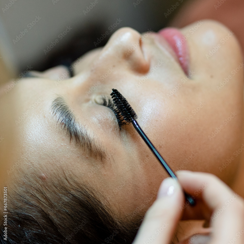 Customer getting eyelash treatment at a beauty salon