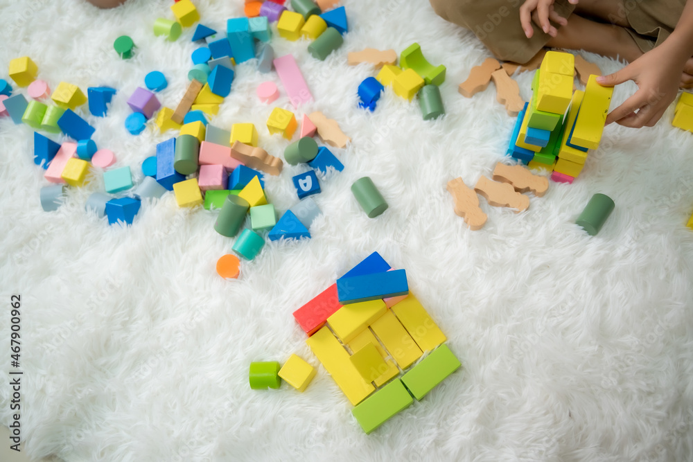 Elementary boy and girl playing on floor with educational toys,Children toddlers at home or daycare,