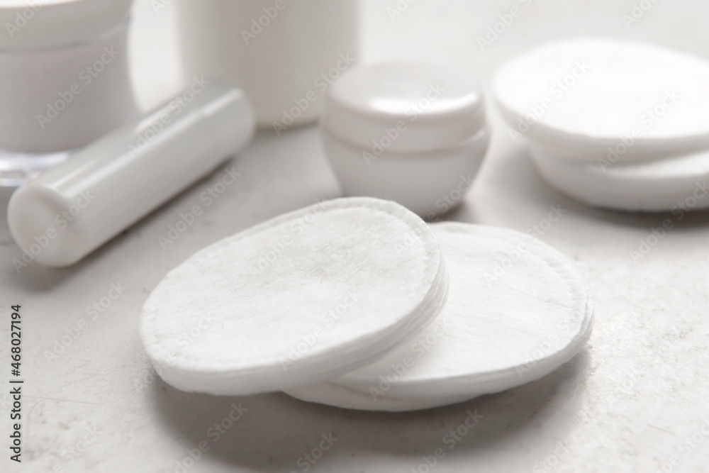 White cotton pads on light background, closeup