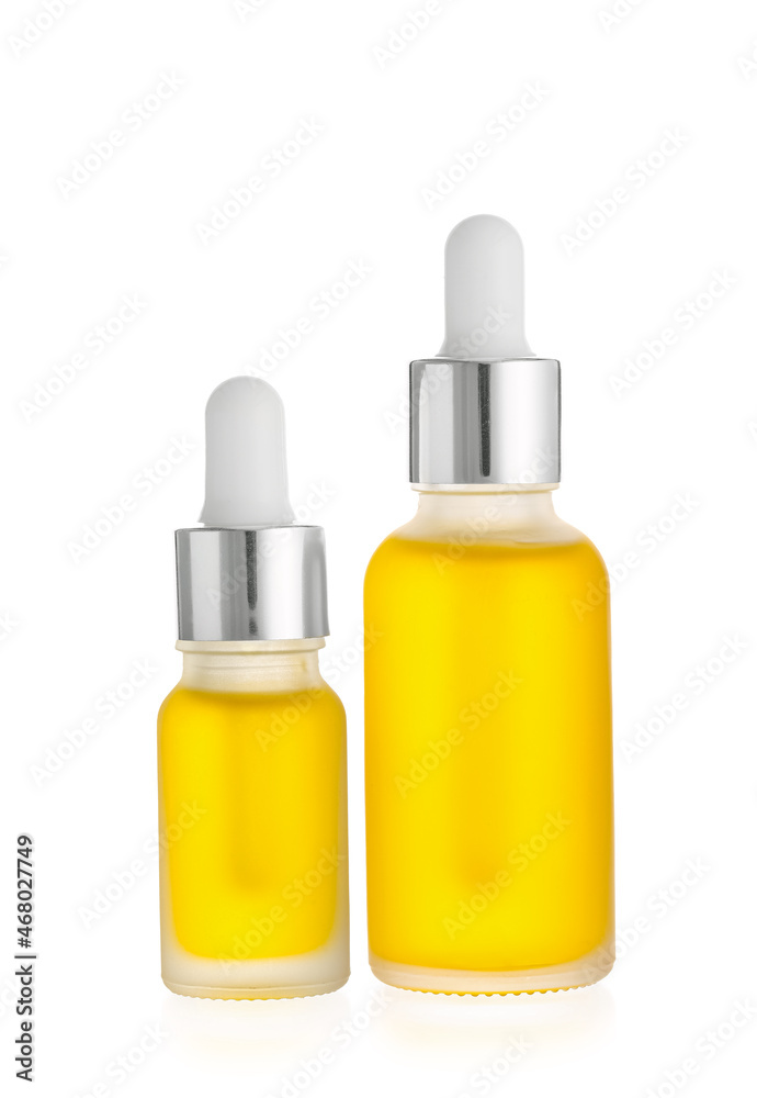 Bottles of essential oil on white background