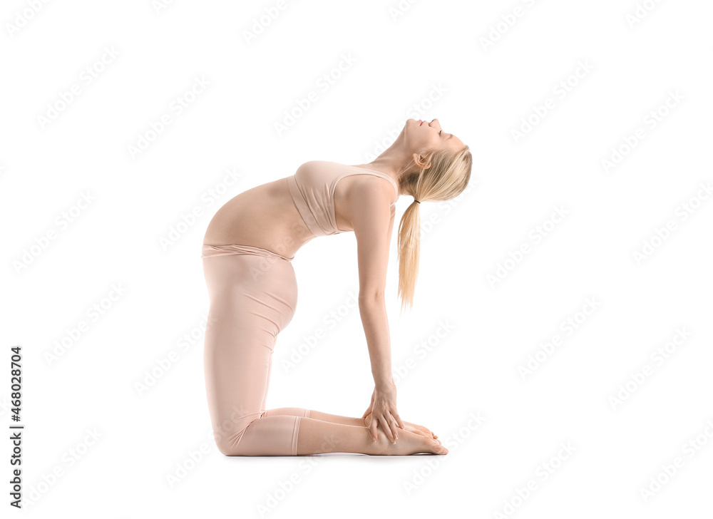 Beautiful young pregnant woman practicing yoga on white background